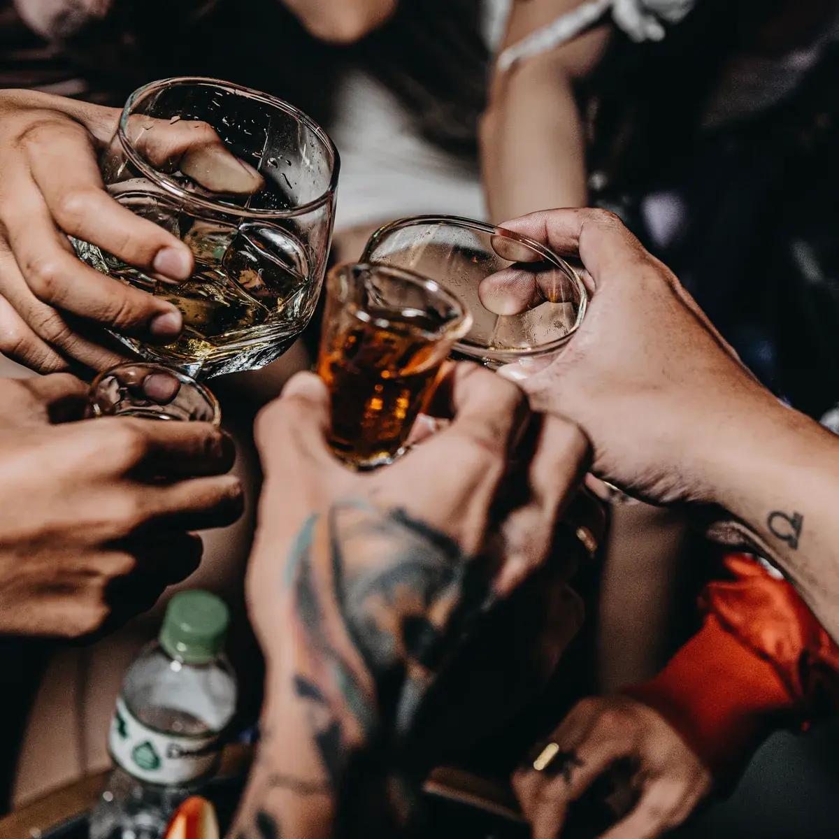 Friends clinking drinks together on a night out