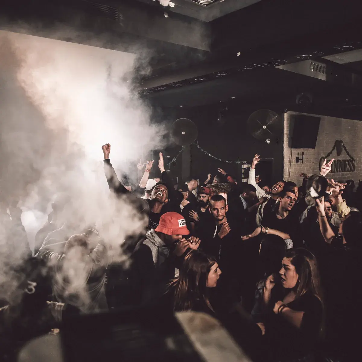 Smoke effects rolling across a busy dancefloor
