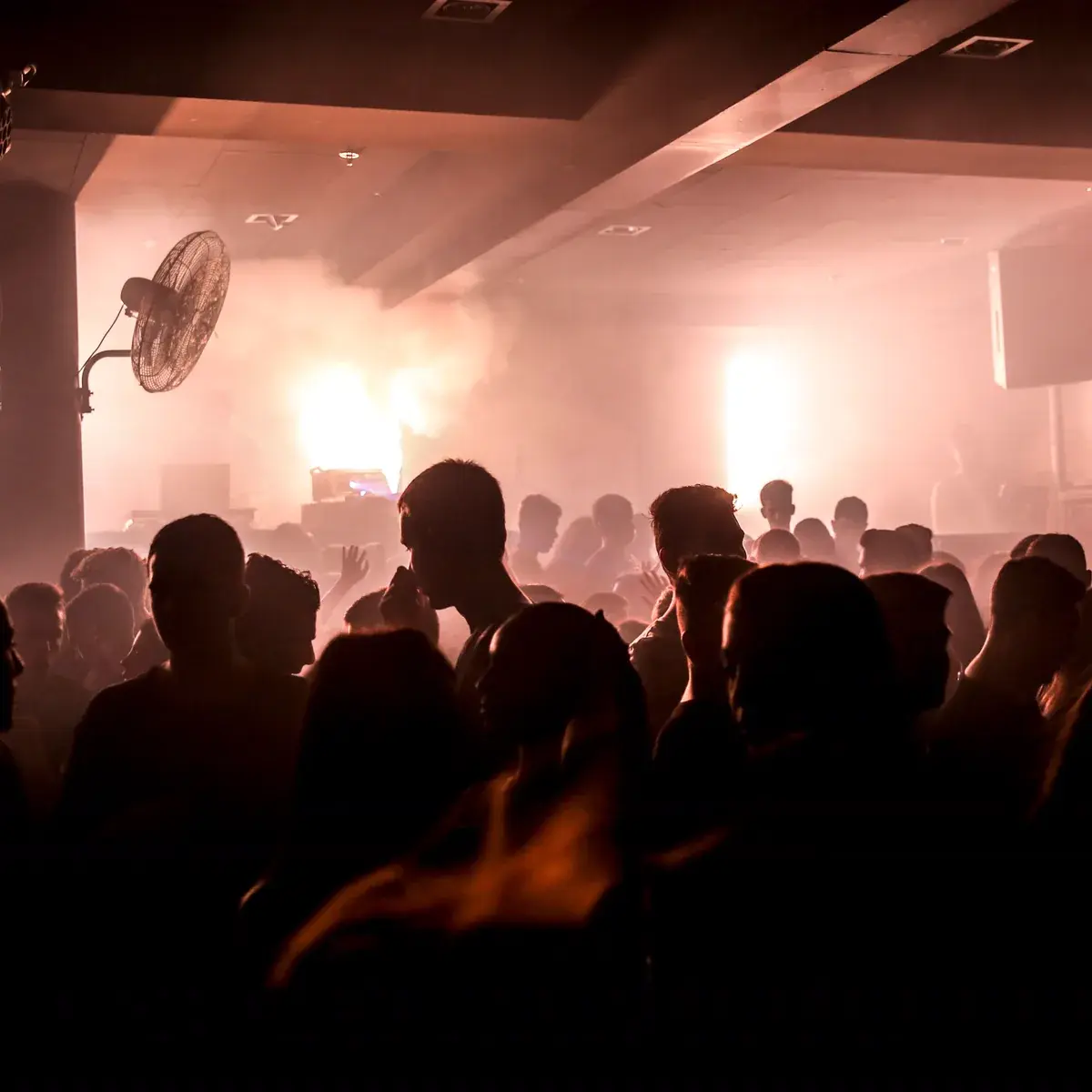A function room full of people under atmospheric lighting